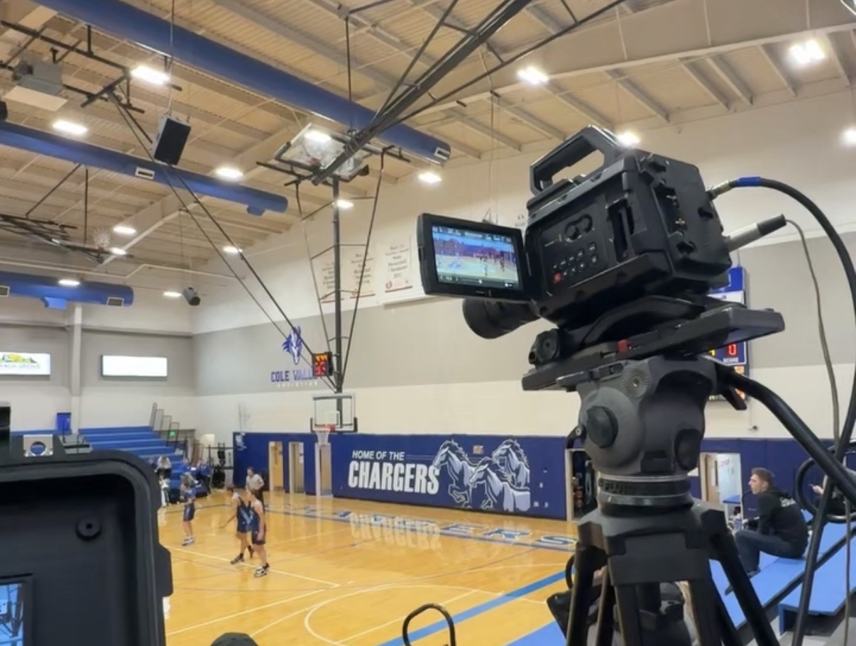 A FLOWW Media broadcast crew filming a high school basketball game